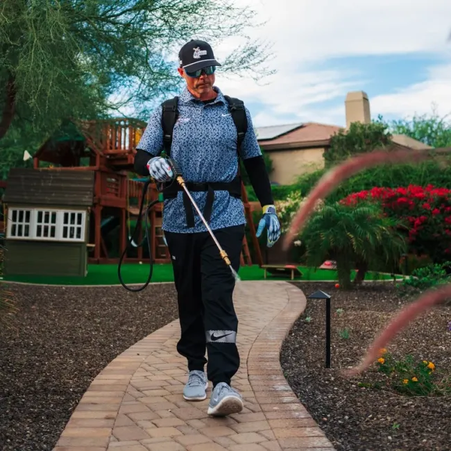 technician spraying walkway