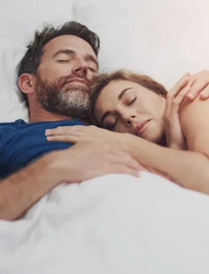couple sleeping comfortably in bed